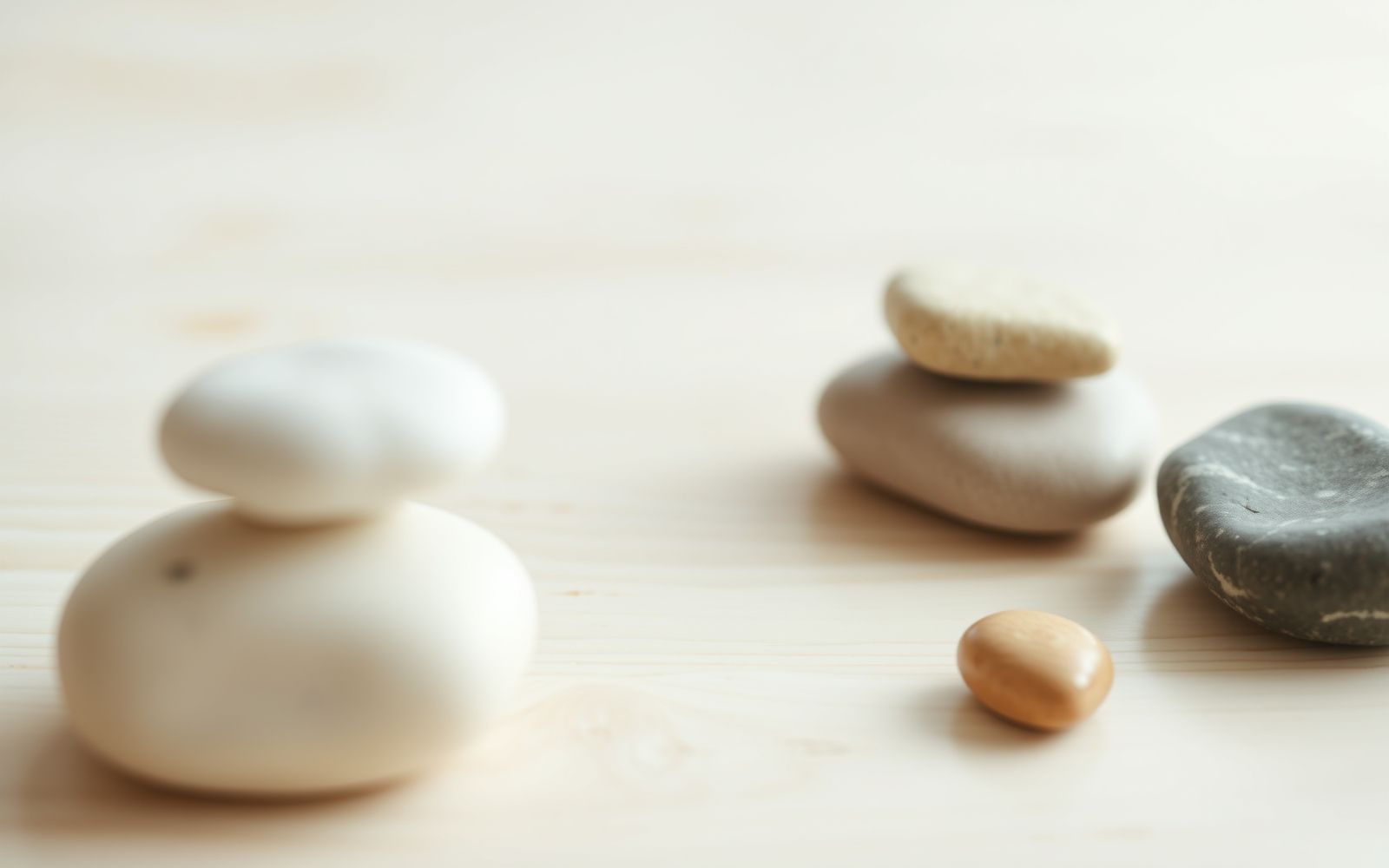 Abstract arrangement of smooth, colorful stones on wood surface representing portfolio diversification and balanced risk management.